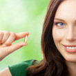 © vgstudio - Woman with Omega 3 fish oil capsule
