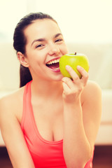 Canvas Print - smiling teenage girl with green apple at home