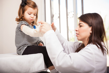 Pediatrician putting a bandage