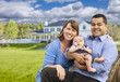 © Andy Dean - Happy Mixed Race Young Family in Front of House