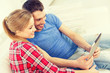 © Syda Productions - smiling happy couple with tablet pc at home