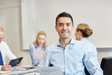 Wall Mural - smiling group of businesspeople meeting in office