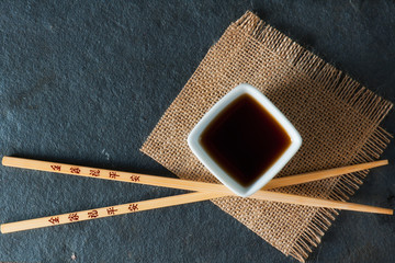 Chopsticks and bowl with soy sauce