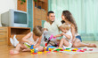 © JackF - Family of four at home with toys