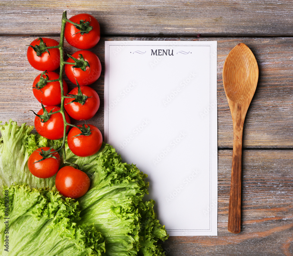 Menu sheet of paper with cherry tomatoes and lettuce