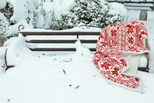 Warm Plaid On Bench In Park In Winter Time