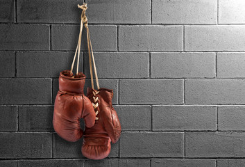 Pair of vintage boxing gloves hanging on a wall