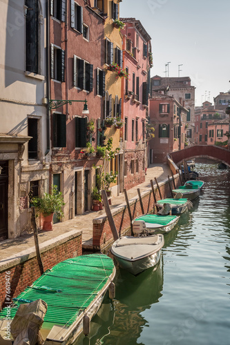 Few boats on a canal in Venice