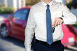 © Saklakova - Young successful businessman offering a car key.