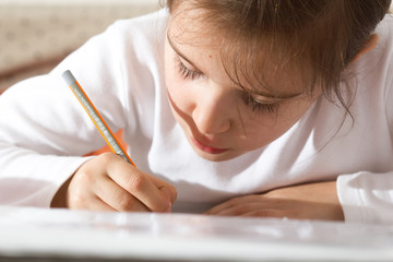 Little schoolgirl doing her homework