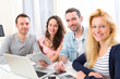 © Production Perig - Group of 4 young attractive people working on a laptop