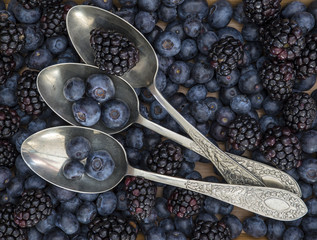 Fruit in rustic table setting with vintage spoons