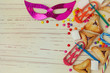 Background for Jewish holiday Purim with mask and cookies