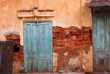 Antique Blue Door On Cracked Brick Wall