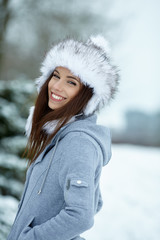 Wall Mural - Attractive young woman in wintertime outdoor