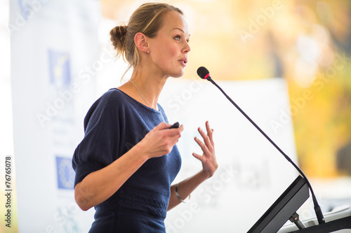 Fotografie, Obraz Pretty, young business woman giving a presentation