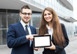 © zadorozhna - Successful young business people are holding a tablet,