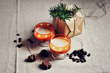 Wall Mural - Baileys Irish cream in shot glasses with dark chocolate sweets,