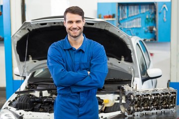 Smiling mechanic looking at camera