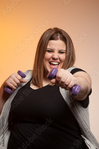 Naklejka - mata magnetyczna na lodówkę Woman exercising with dumbbells.