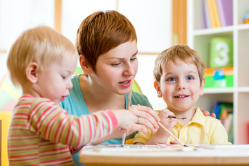 Wall Mural - cute woman teaching kids to paint