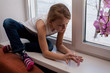 © trofimov_pavel - Beautiful little girl sitting near a window.