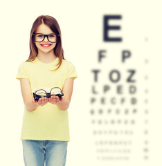 Canvas Print - smiling cute little girl in black eyeglasses