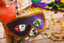 Mardi Gras: Party Mask Sits Against Tropical Hurricane Cocktail