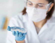 Close Up Of Scientist Holding Petri Dish In Lab