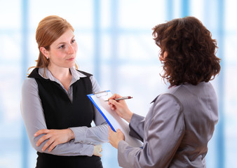 Woman making notes at job interview