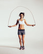 Fit young woman skipping rope