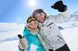 © goodluz - Cheerful couple having fun at top of ski slope