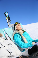 Wall Mural - Couple of skiers sunbathing at top of ski slope