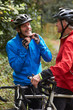 © micromonkey - Two Mature Male Cyclists Riding Bikes Along Path