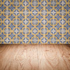 Wood table top and blur vintage ceramic tile pattern wall