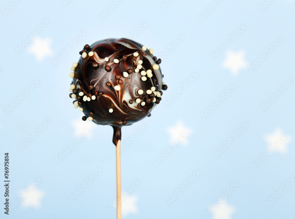 Tasty cake pop on blue background