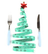 © Africa Studio - Measuring tape and cutlery with Christmas decoration isolated