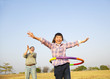 © Tom Wang - happy kid playing  hula hoops outdoors