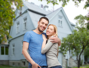 Sticker - smiling couple hugging over house background