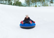 © Syda Productions - happy teenage girl sliding down on snow tube