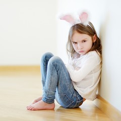 Angry little girl wearing bunny ears