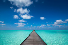 Wooden Pier With Blue Sea And Sky Background