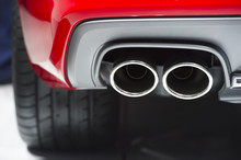 Chrome Exhaust Pipe Of Red Powerful Sport Car Bumper