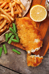 Wall Mural - Breaded fried fish fillet and potatoes with asparagus and lemon