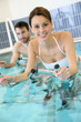 © goodluz - Couple in pool doing aquabike training