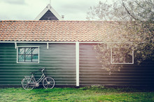 Old Bicycle Leaning Against Wooden Barn