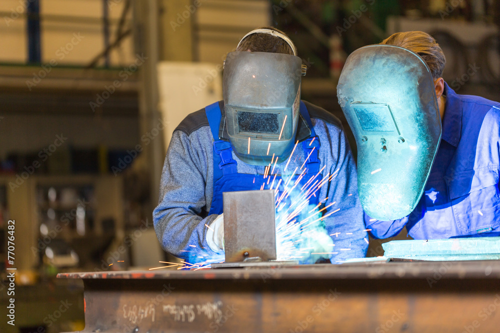 Two steel construction workers welding metal - obrazy, fototapety, plakaty 