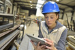 © goodluz - Woman engineer in steel plant checking production