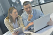 © goodluz - Business people in office working on laptop and tablet