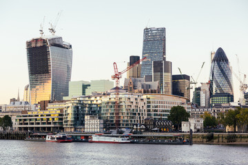 Wall Mural - River Thames and Modern Skyscrapers on Background at Sunset